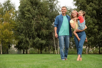 Happy family spending time together in park on sunny summer day