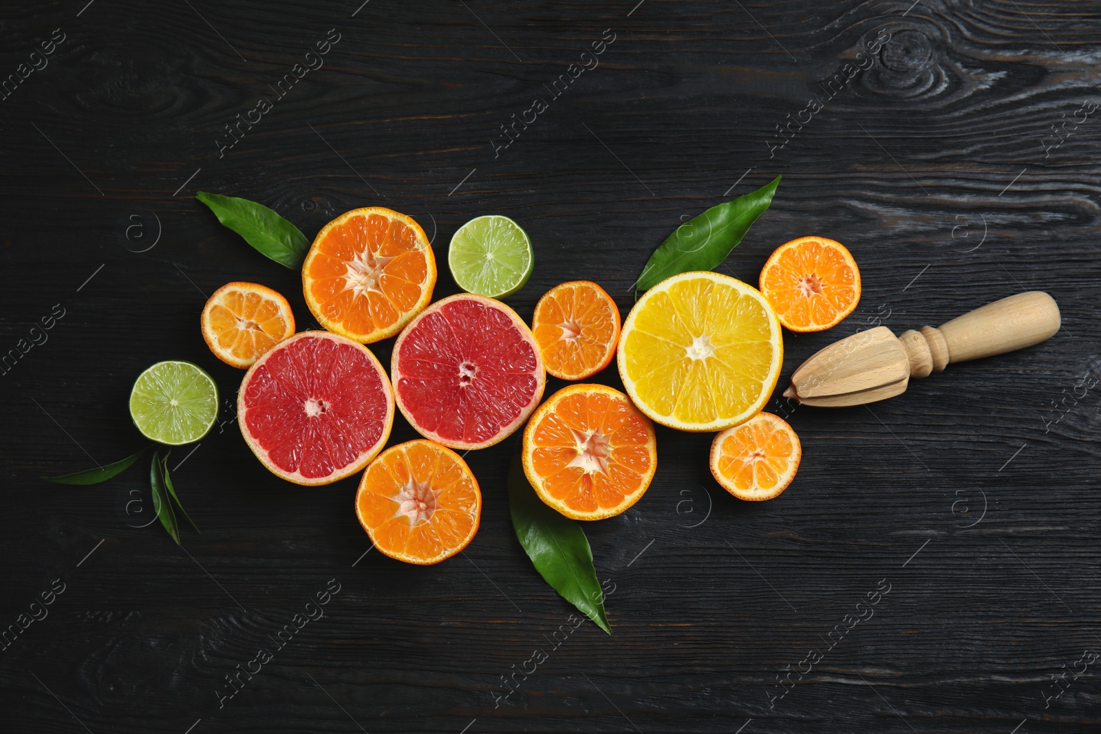 Photo of Different citrus fruits on wooden background, flat lay