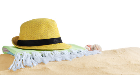 Photo of Folded towel, hat and shells on sand against white background. Beach objects