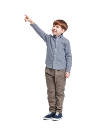Photo of Little boy pointing at something on white background