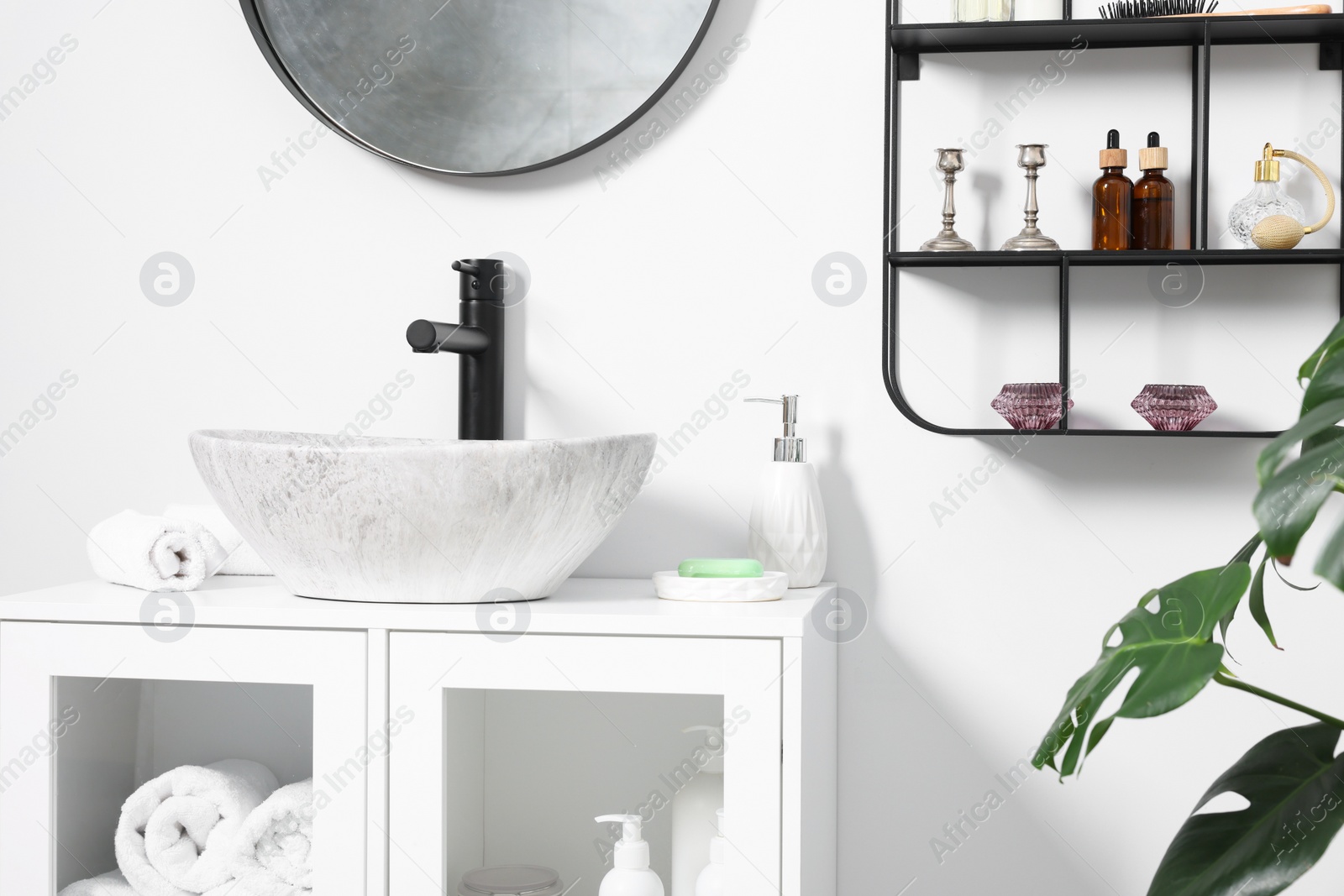 Photo of Different bath accessories, personal care products and bathroom vanity indoors