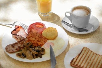 Photo of Delicious breakfast with fried meat and vegetables served on beige table