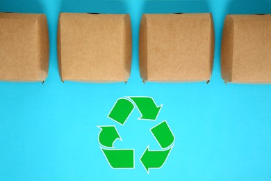 Paper boxes and recycling symbol on turquoise background, flat lay