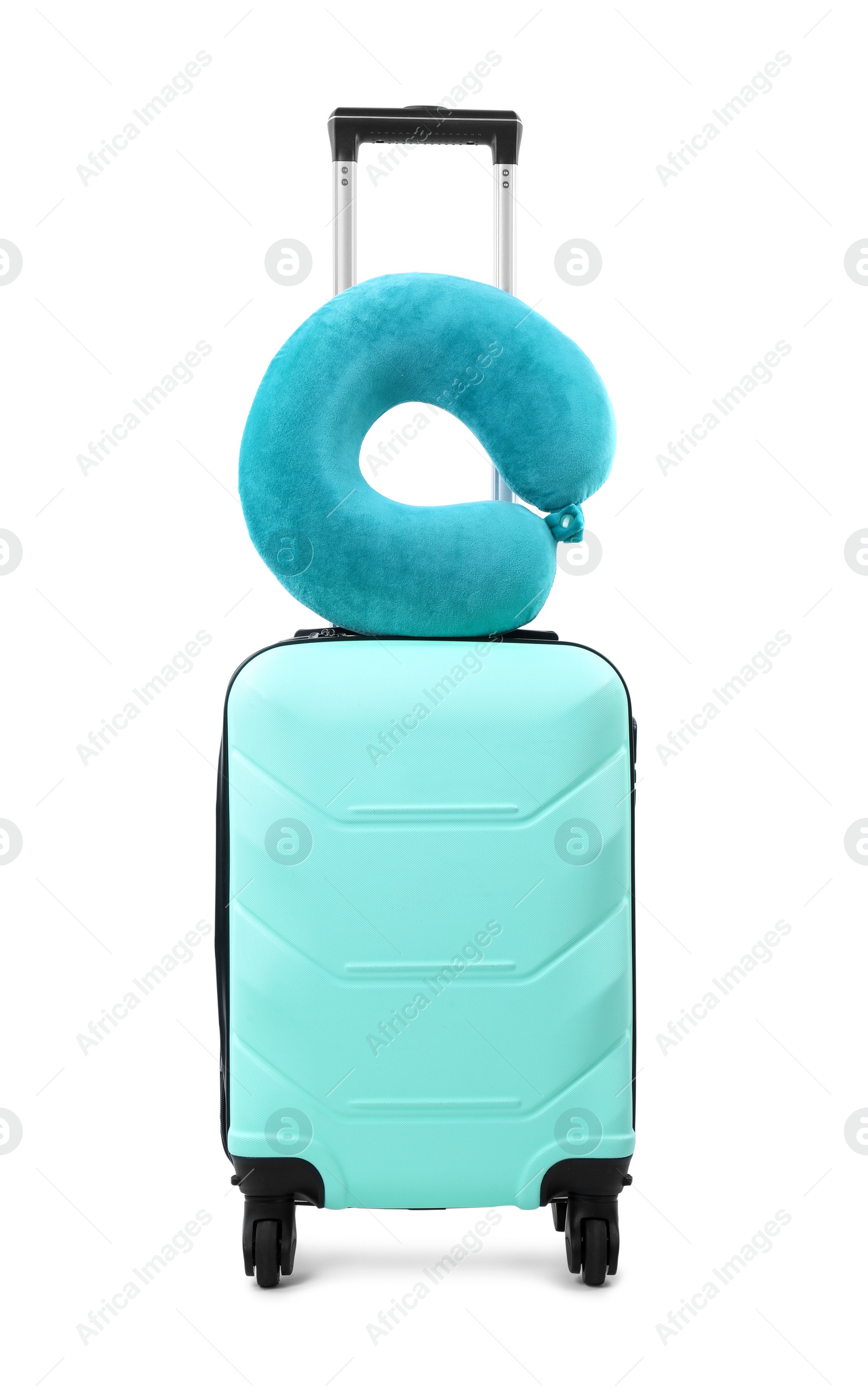 Photo of Soft travel pillow on turquoise suitcase isolated on white