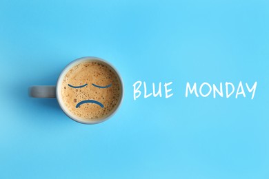Image of Cup of coffee and text Blue Monday on turquoise background, top view