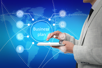 Business plan. Virtual screen with different icons and man using tablet , closeup