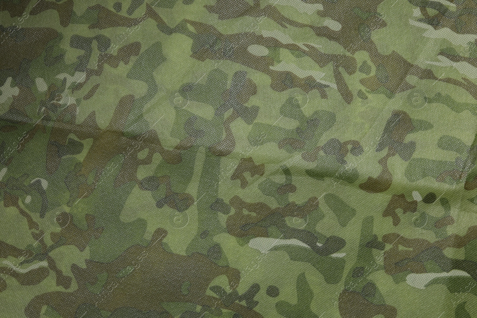 Photo of Texture of camouflage fabric as background, top view