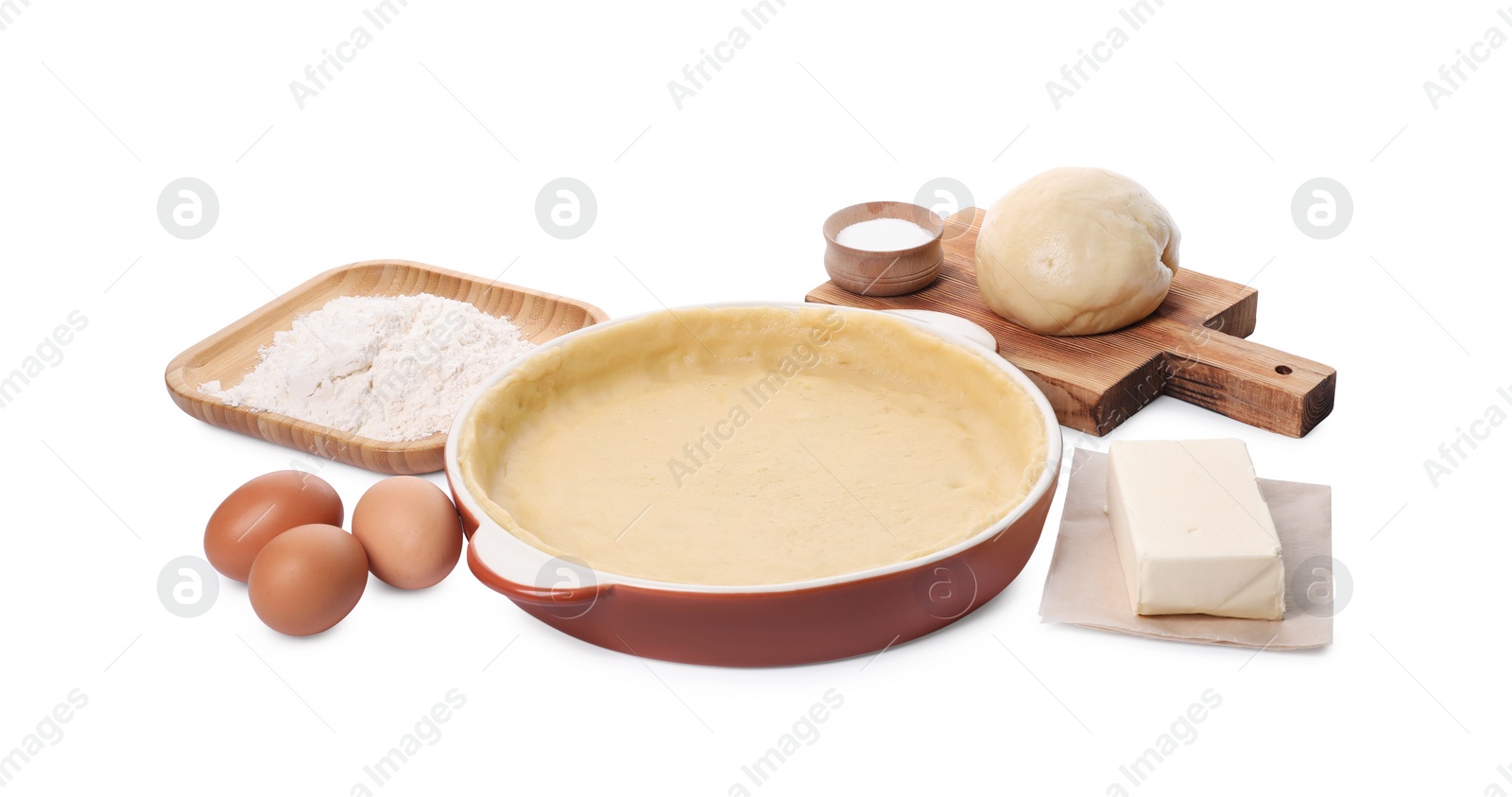 Photo of Pie tin with fresh dough and ingredients isolated on white. Making quiche