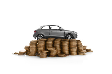 Miniature automobile model and money on white background. Car buying