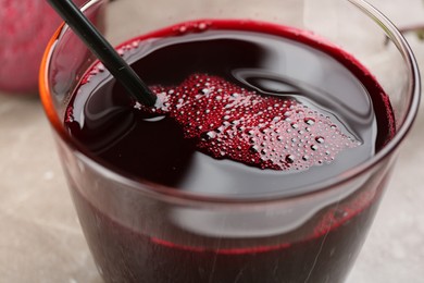 Freshly made beet juice in glass on table, closeup
