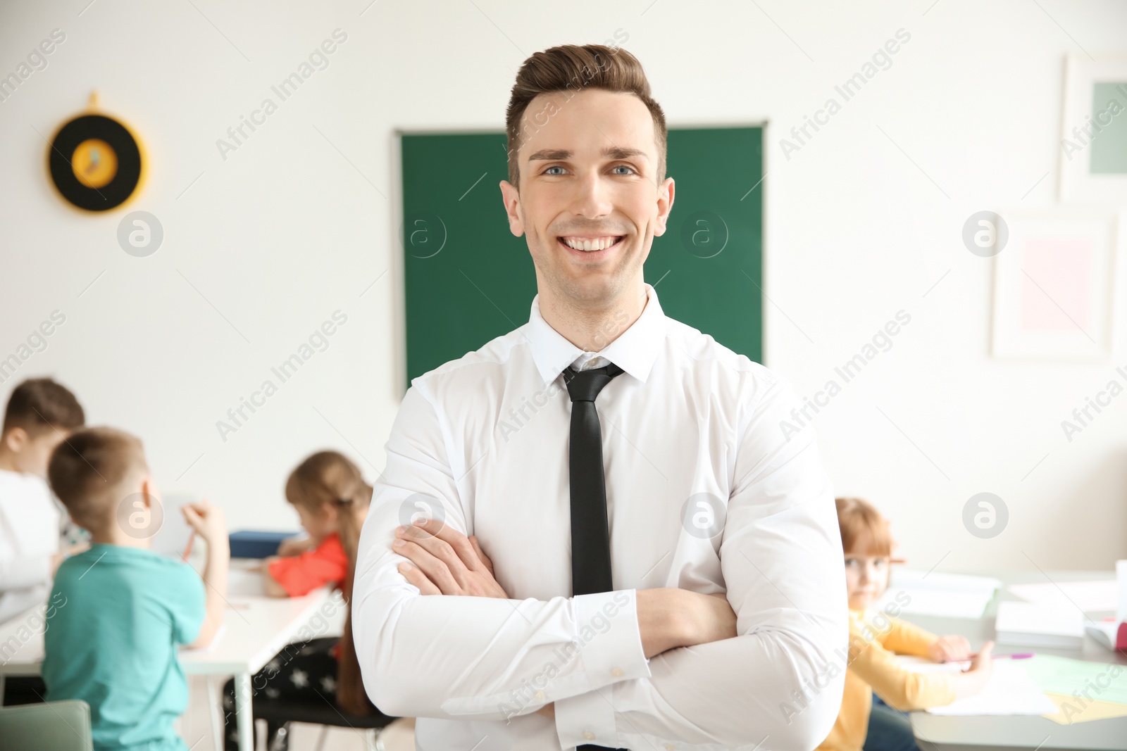 Photo of Young teacher in classroom at school