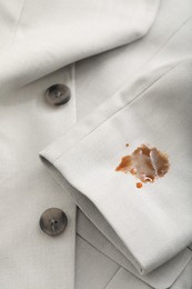 Photo of Dirty jacket with stain of coffee as background, closeup