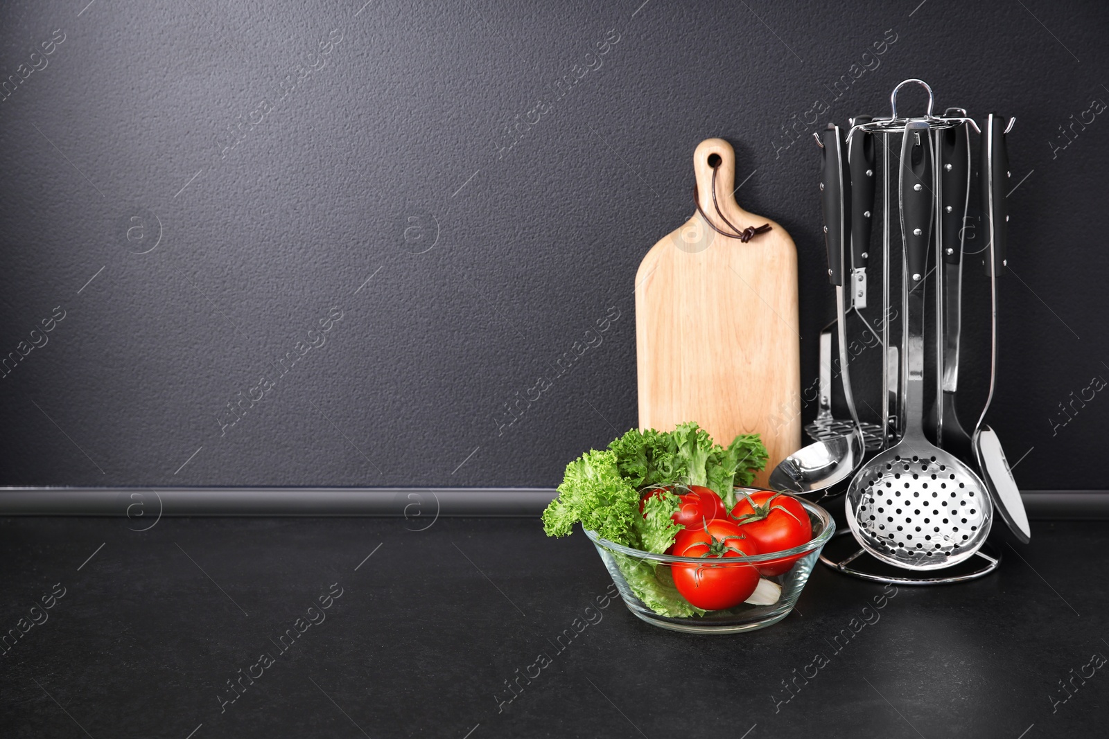 Photo of Composition with kitchenware on table against grey background. Space for text