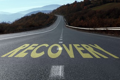 Image of Start to live without alcohol addiction. Word RECOVERY on asphalt highway
