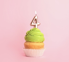 Photo of Birthday cupcake with number four candle on pink background
