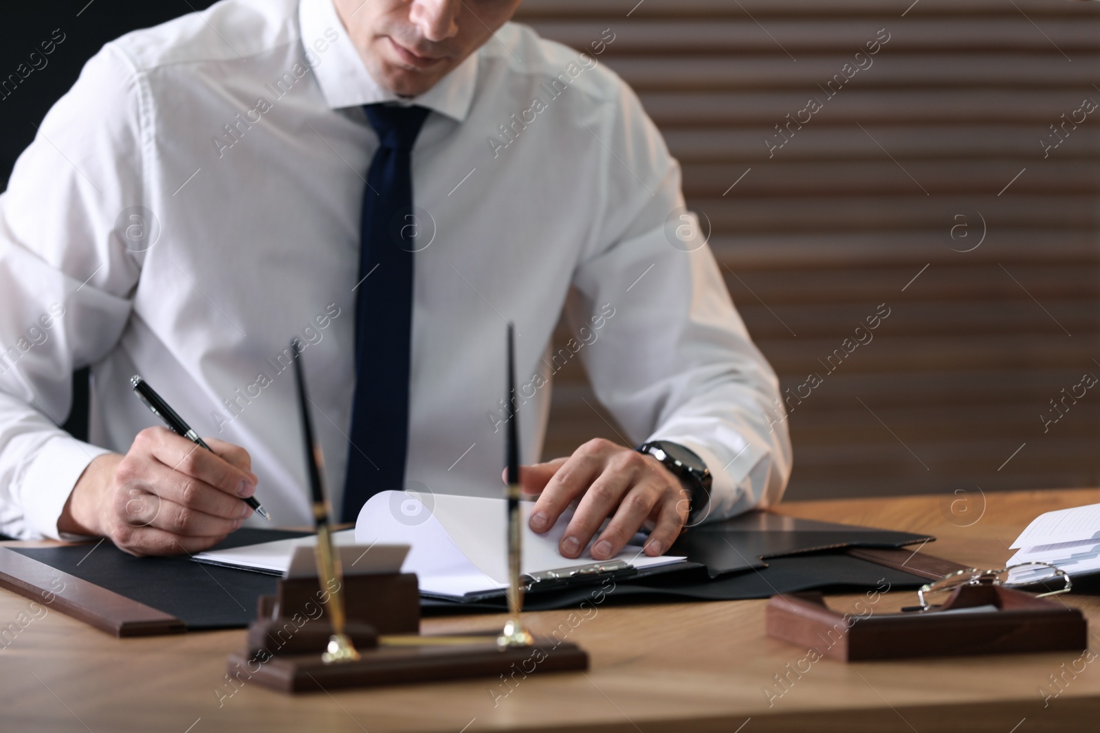 Photo of Male lawyer working at table in office, closeup