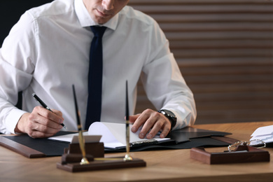 Male lawyer working at table in office, closeup