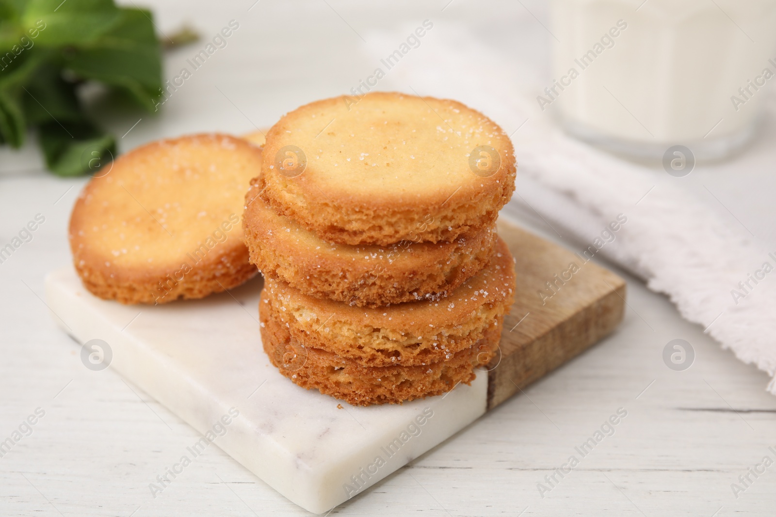 Photo of Tasty sweet sugar cookies on white wooden table, closeup