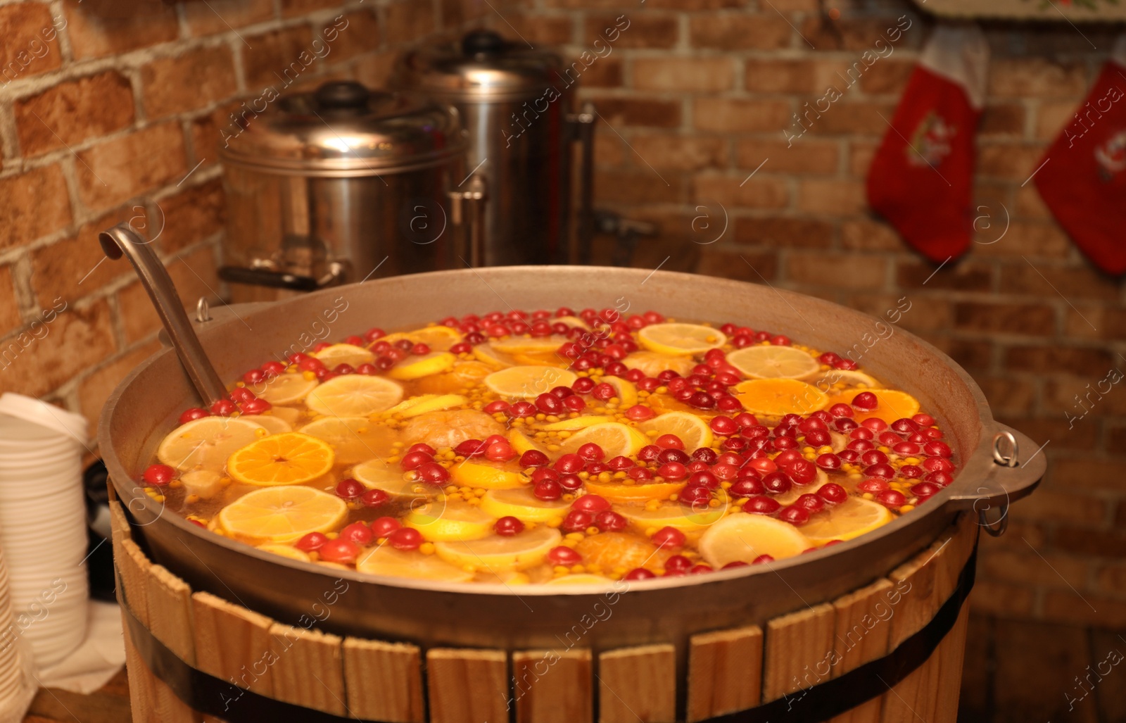 Photo of Large cauldron with tasty mulled wine at winter fair