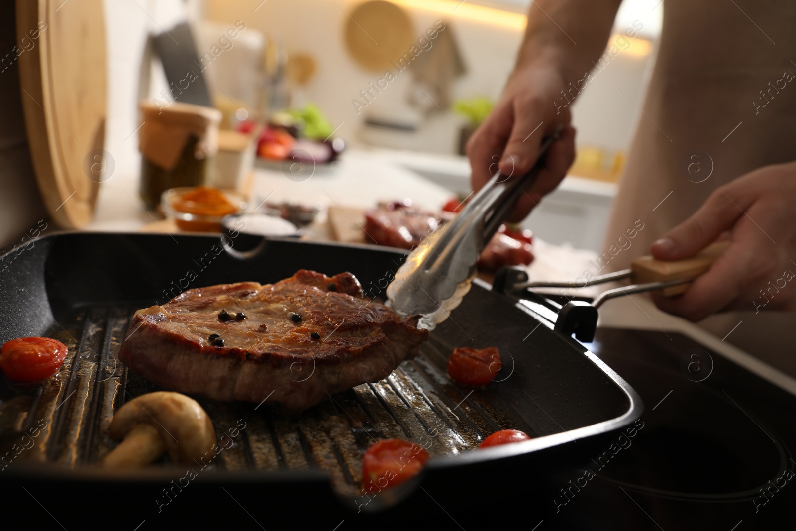 Photo of Man cooking meat with vegetables in frying pan, closeup
