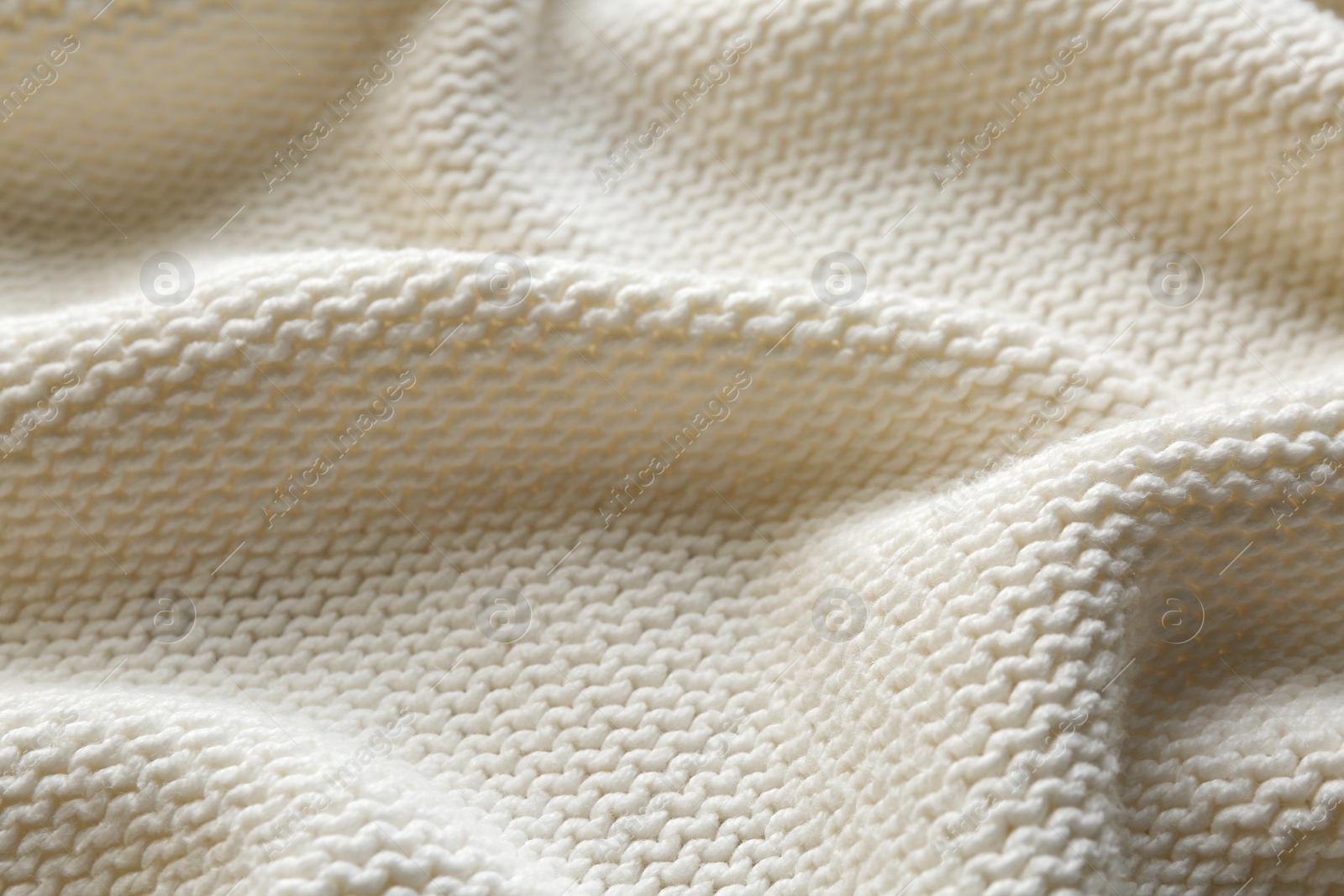 Photo of Beautiful white knitted fabric as background, closeup