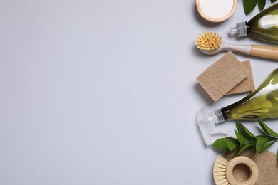 Photo of Flat lay composition with different cleaning supplies on light gray background, space for text