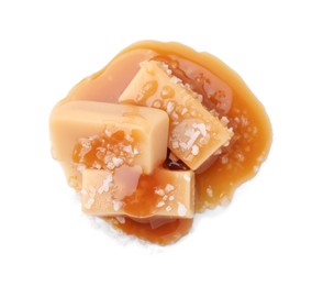 Yummy caramel candies and sea salt isolated on white, top view