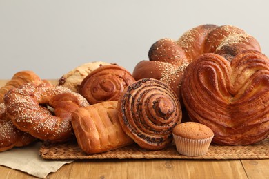 Photo of Different tasty freshly baked pastries on wooden table