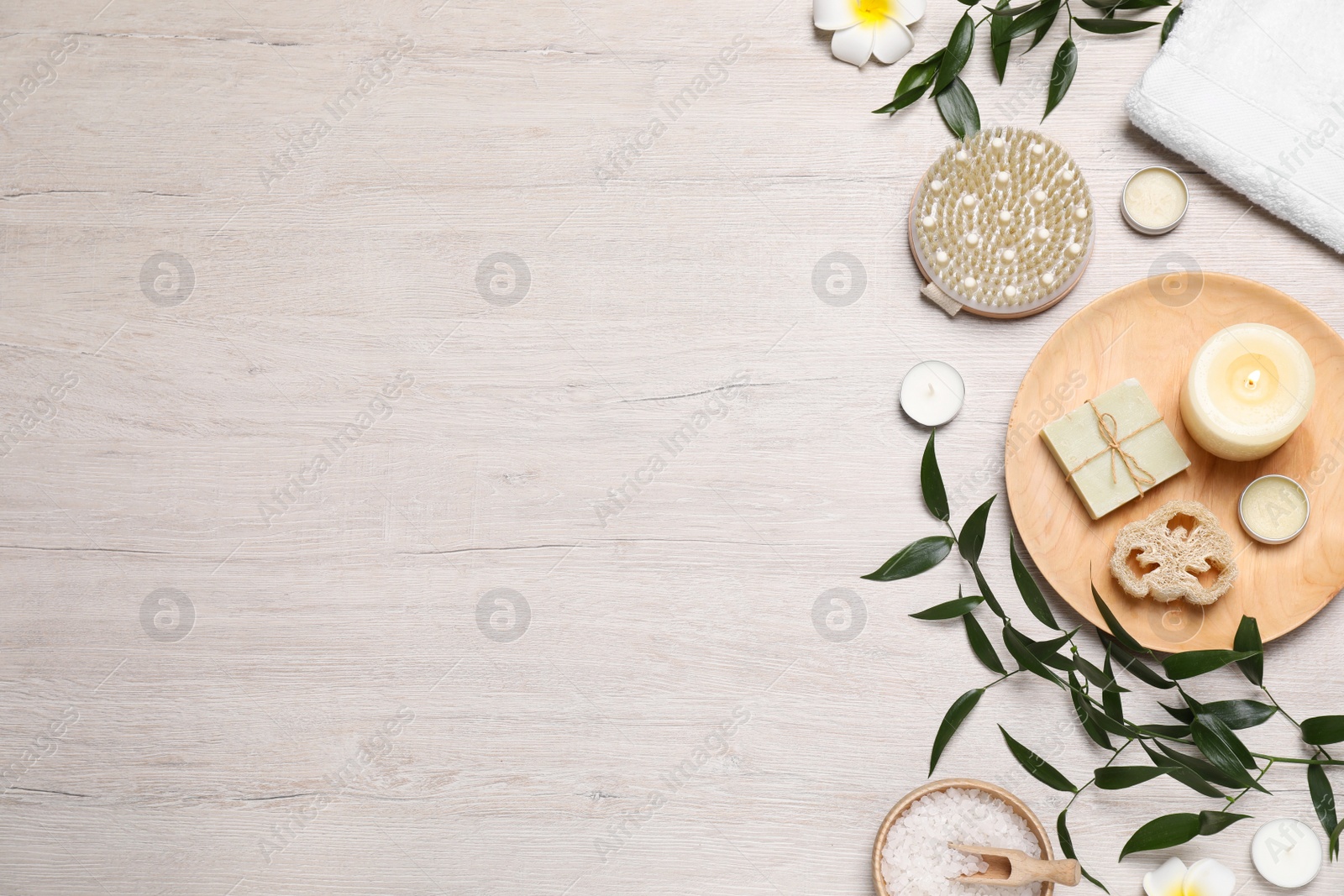 Photo of Flat lay composition with spa products on wooden table. Space for text