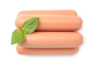 Photo of Many delicious boiled sausages and basil on white background, top view