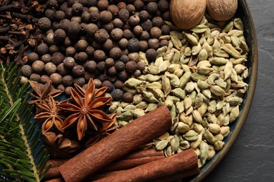 Photo of Different spices, nuts and fir branches on table, top view