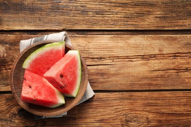 Photo of Delicious fresh watermelon slices on wooden table, top view. Space for text