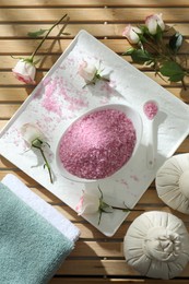 Photo of Flat lay composition with pink sea salt on wooden table