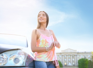 Young woman near car outdoors on sunny day