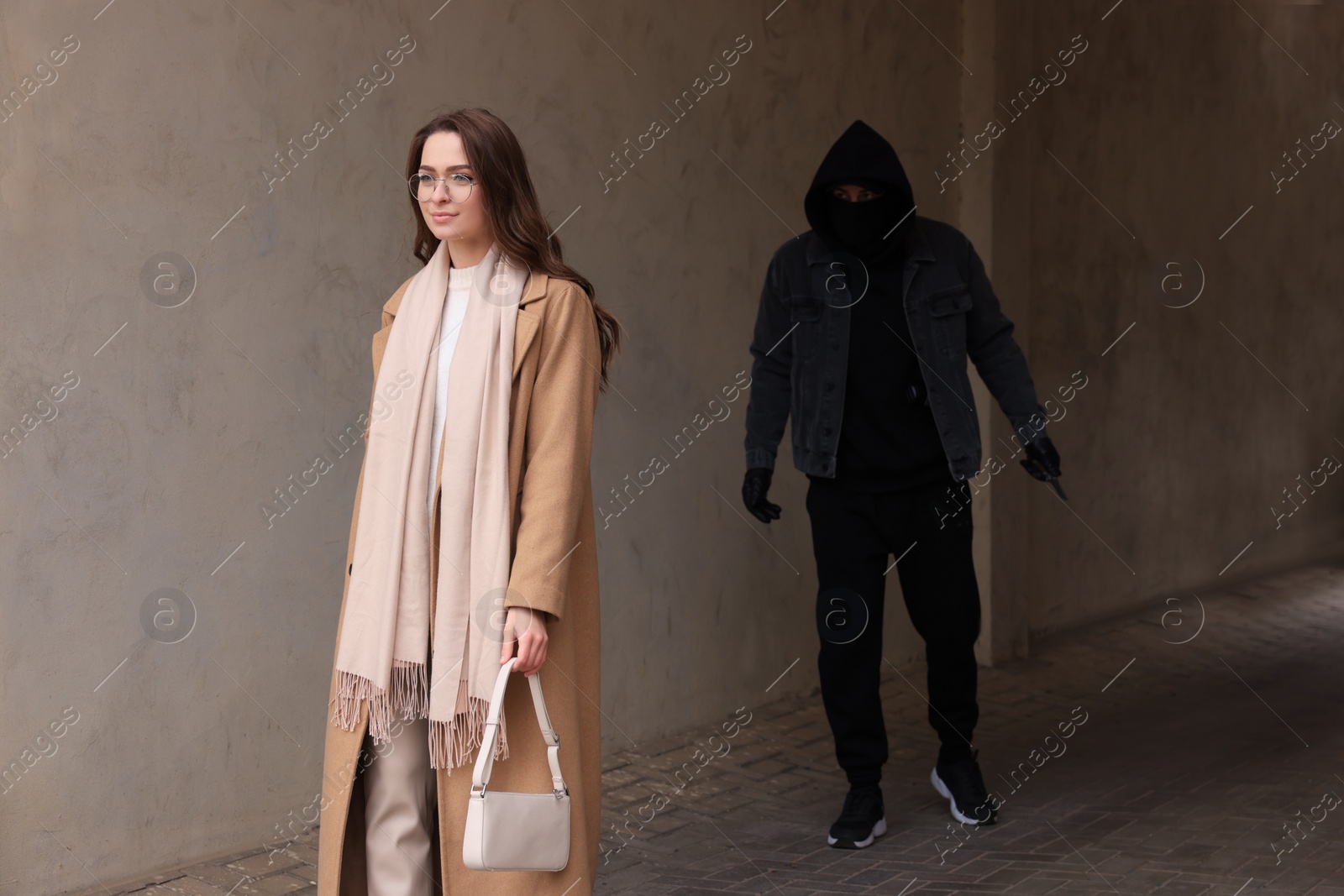 Photo of Man with knife stalking young woman in alley