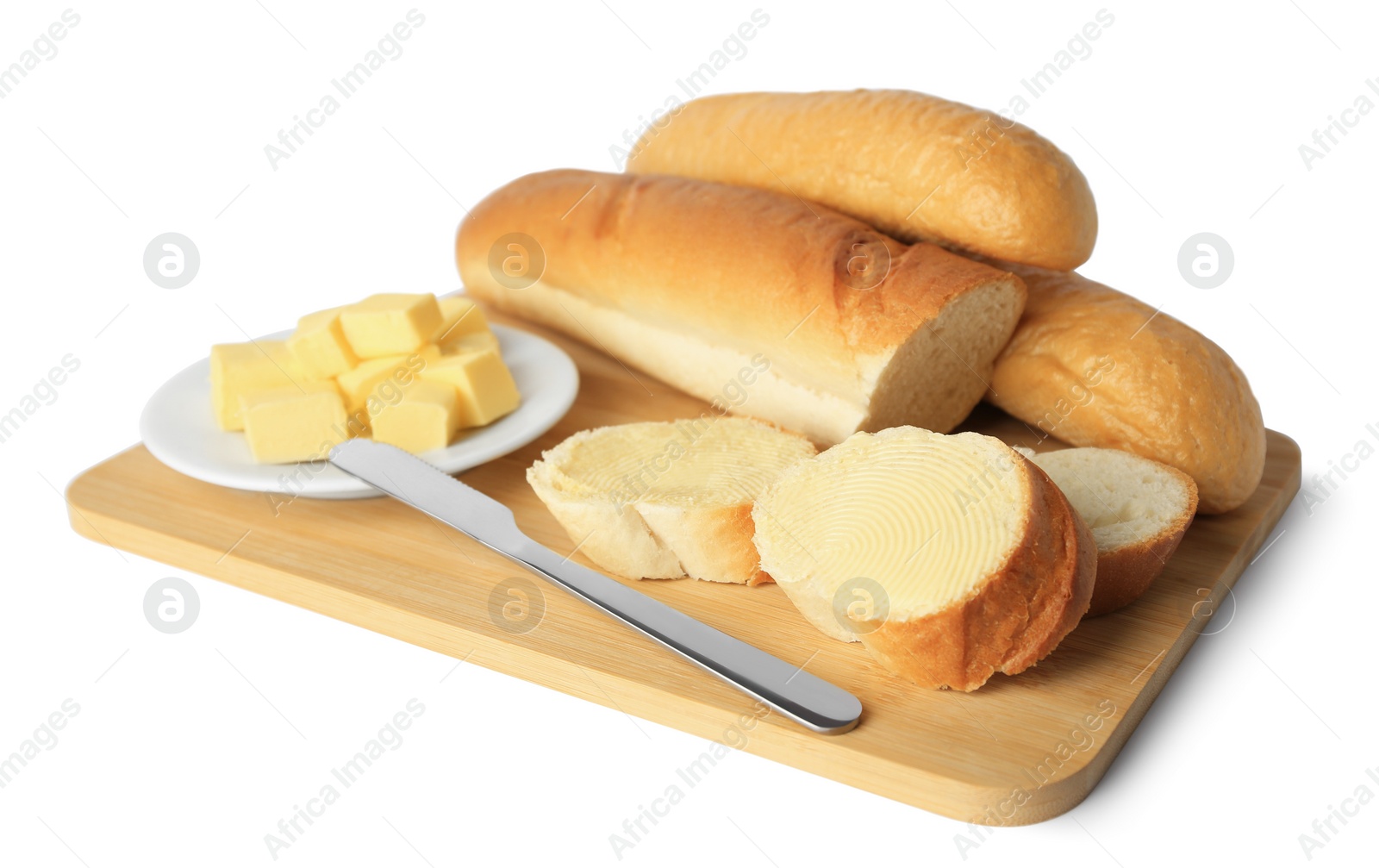 Photo of Whole and cut baguettes with fresh butter on white background