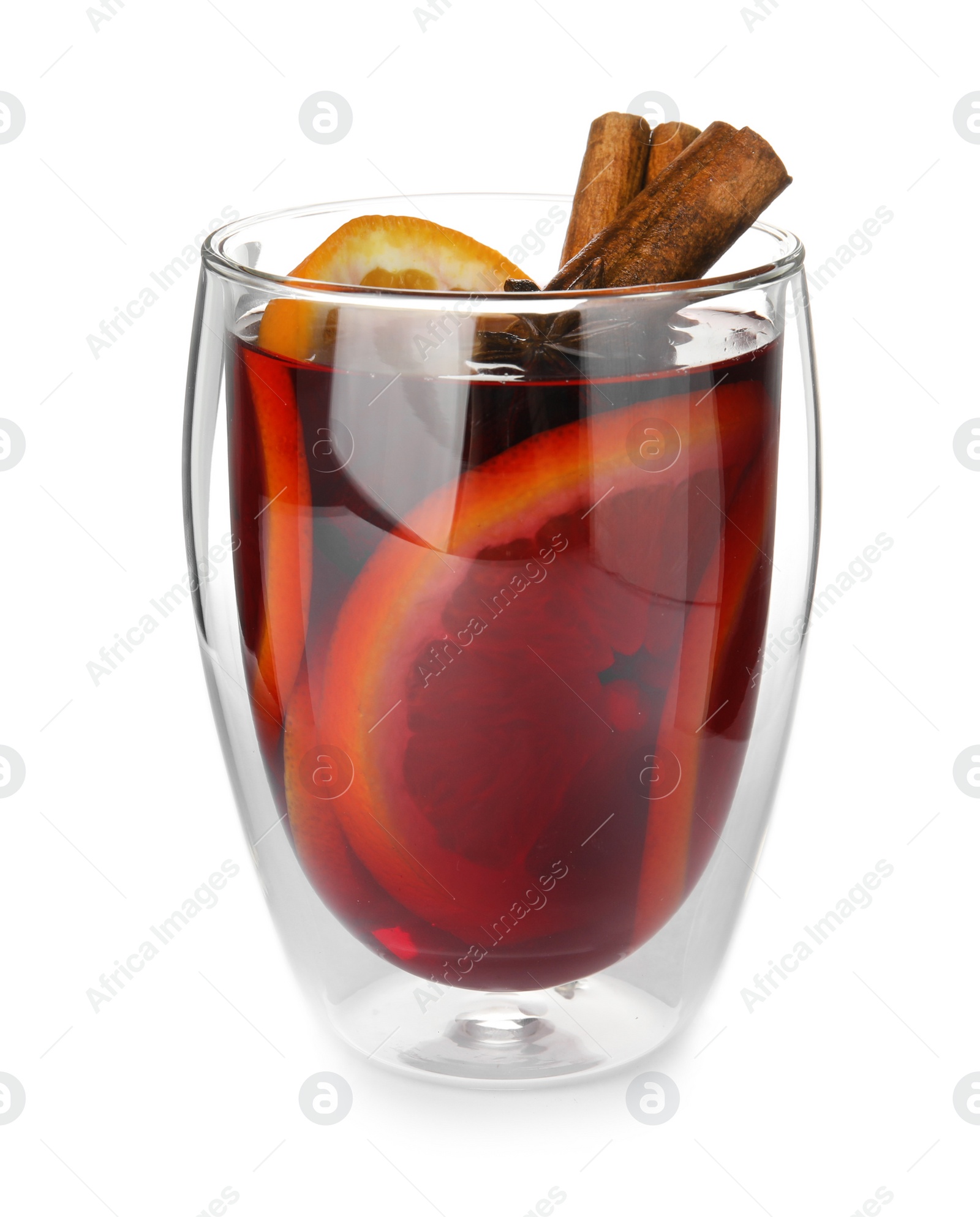 Photo of Glass of mulled wine with spices isolated on white