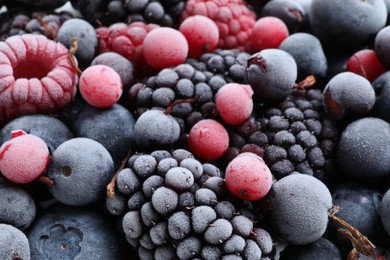 Photo of Mix of different frozen berries as background, closeup