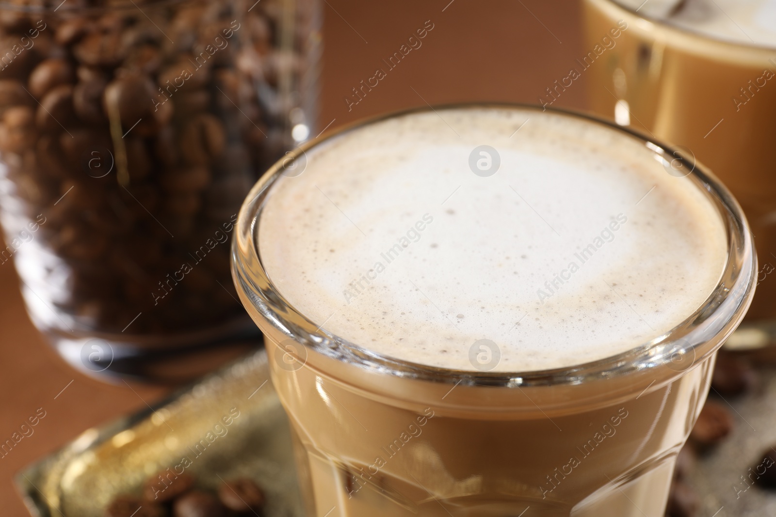 Photo of Aromatic coffee with milk in glass on table, closeup