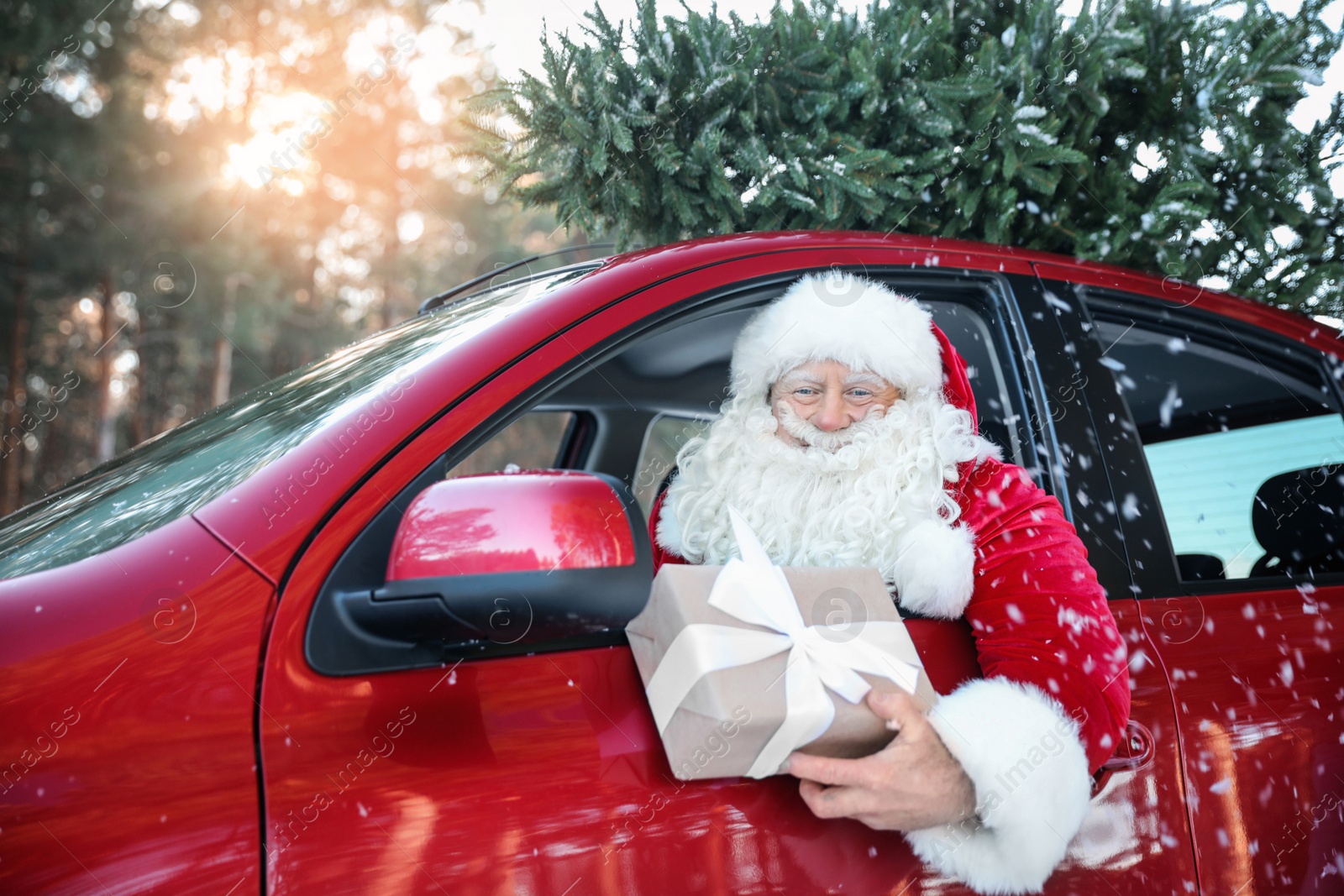 Photo of Authentic Santa Claus in car with gift box, view from outside