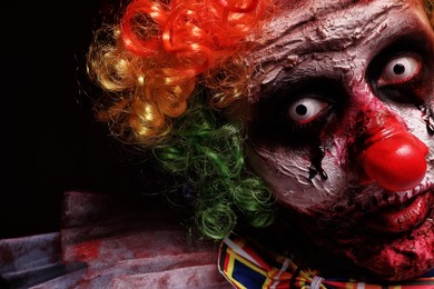 Photo of Portrait of terrifying clown, closeup. Halloween party costume