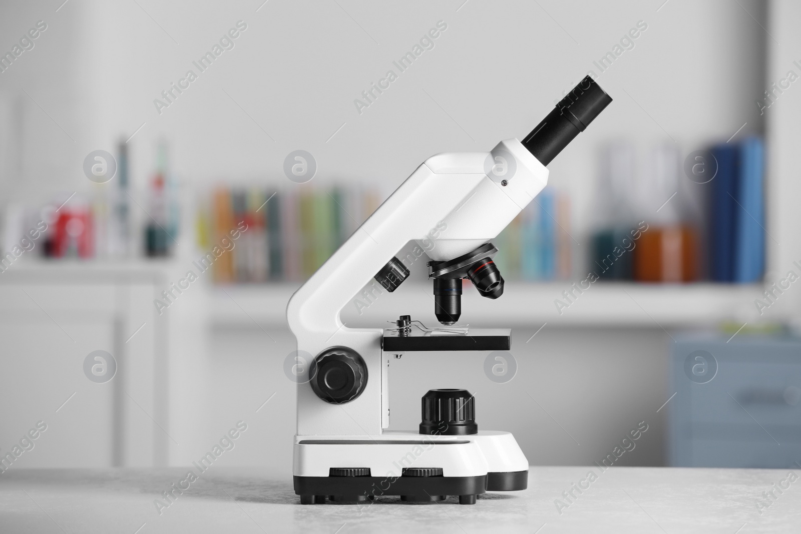 Photo of Modern medical microscope on white table in laboratory