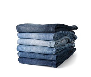 Stack of different folded jeans isolated on white