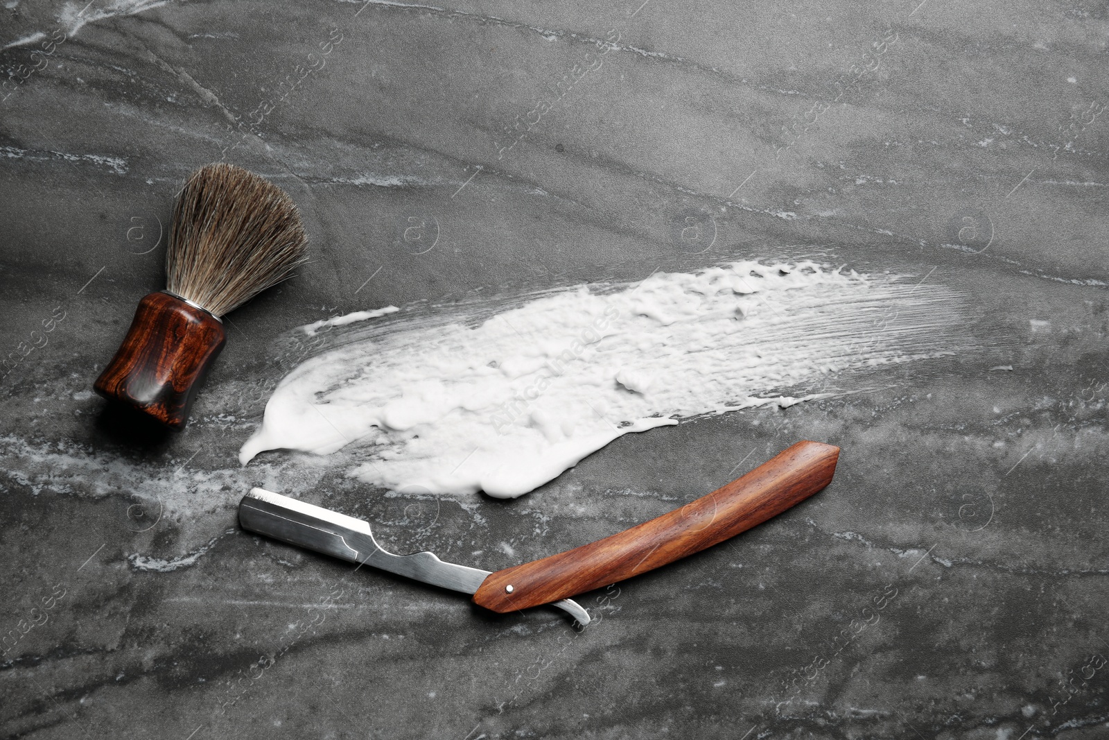 Photo of Flat lay composition with shaving accessories and foam stroke on gray background