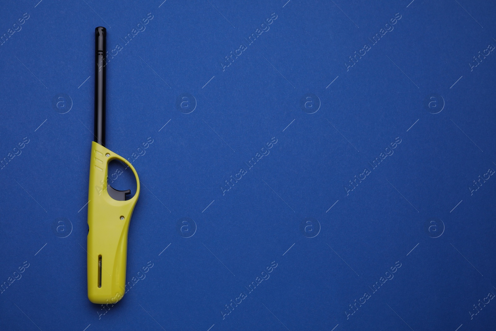 Photo of One gas lighter on blue background, top view. Space for text