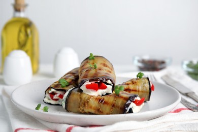 Photo of Delicious baked eggplant rolls served on table, closeup