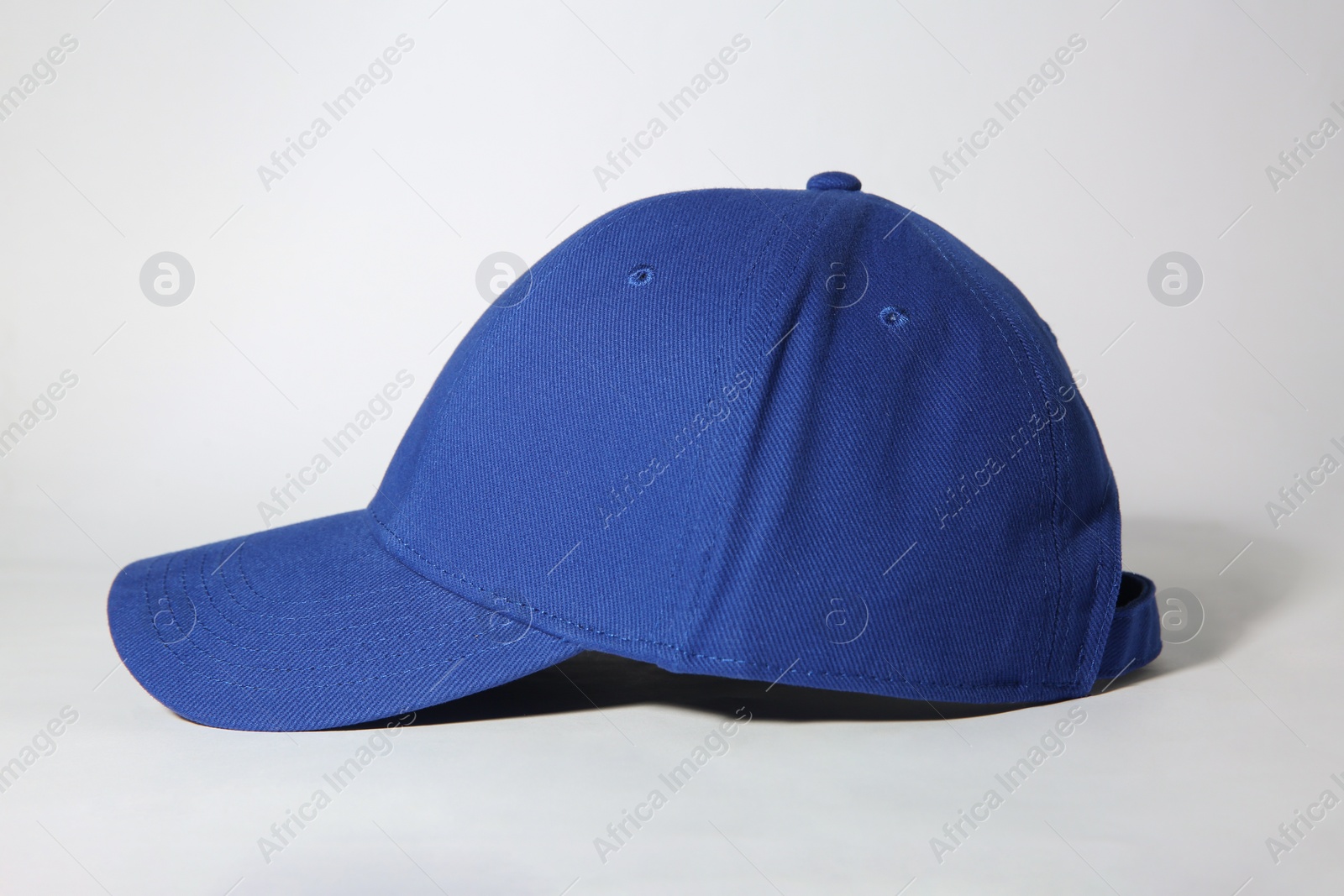 Photo of Stylish blue baseball cap on white background