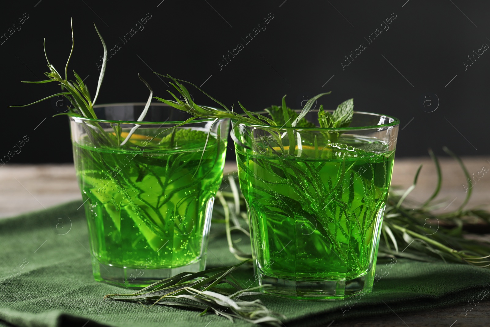 Photo of Glasses of refreshing tarragon drink on table, closeup