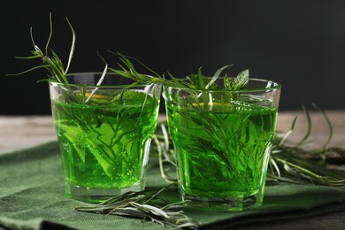 Photo of Glasses of refreshing tarragon drink on table, closeup