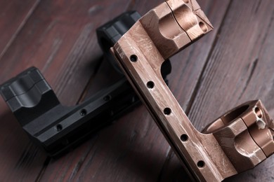 Photo of Quick disconnect sniper cantilever scope mounts on wooden table, closeup